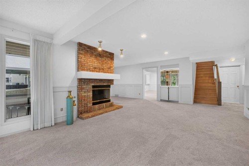 12 Sunset Way, Priddis Greens, AB - Indoor With Fireplace