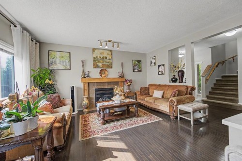 1600 Copperfield Boulevard Se, Calgary, AB - Indoor Photo Showing Living Room With Fireplace