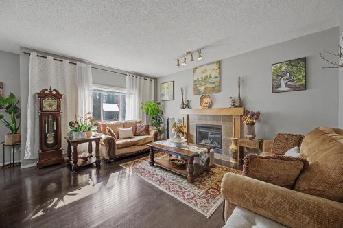 1600 Copperfield Boulevard Se, Calgary, AB - Indoor Photo Showing Living Room With Fireplace