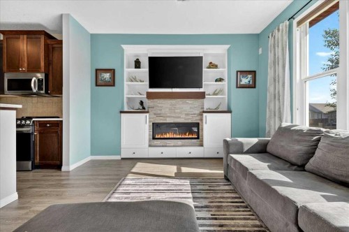 21 Mcintyre Place Nw, Langdon, AB - Indoor Photo Showing Living Room With Fireplace