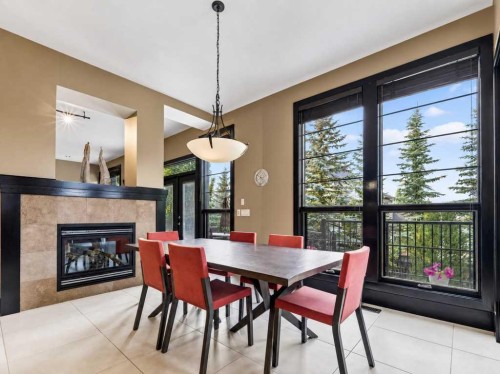 10 Aspen Ridge Way Sw, Calgary, AB - Indoor Photo Showing Dining Room With Fireplace