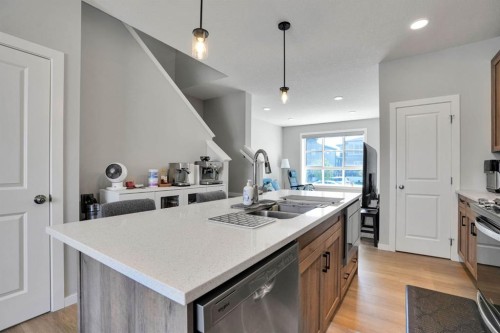 152 Belmont Way Sw, Calgary, AB - Indoor Photo Showing Kitchen With Double Sink With Upgraded Kitchen
