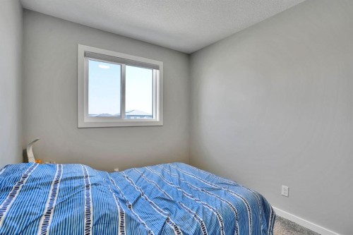 152 Belmont Way Sw, Calgary, AB - Indoor Photo Showing Bedroom