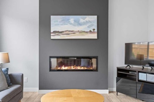 338 Magnolia Way Se, Calgary, AB - Indoor Photo Showing Living Room With Fireplace
