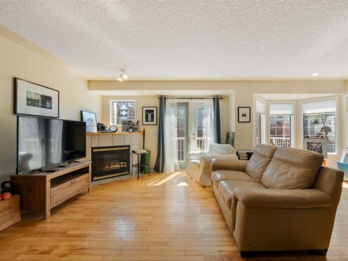 81 Prominence View Sw, Calgary, AB - Indoor Photo Showing Living Room With Fireplace