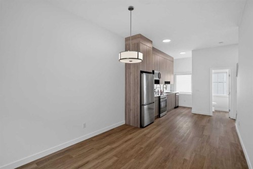 202-101 Panatella Square Nw, Calgary, AB - Indoor Photo Showing Kitchen With Stainless Steel Kitchen