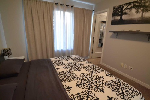 613 Hillcrest Road Sw, Airdrie, AB - Indoor Photo Showing Bedroom