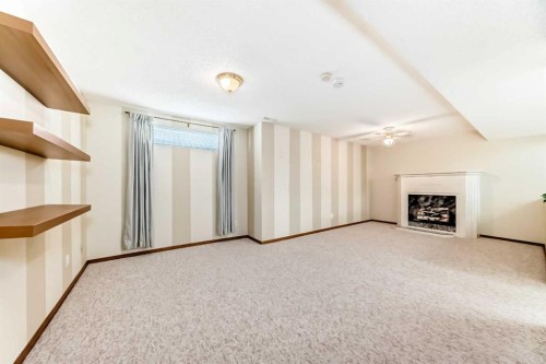 16 Edenwold Green Nw, Calgary, AB - Indoor Photo Showing Other Room With Fireplace