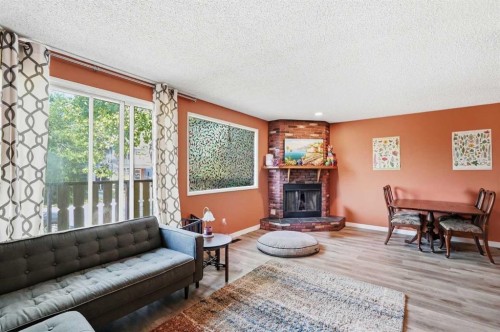 7343 36 Avenue Nw, Calgary, AB - Indoor Photo Showing Living Room With Fireplace