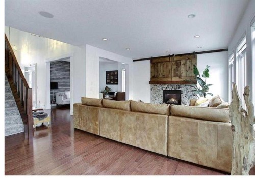 210 Panatella Heath Nw, Calgary, AB - Indoor Photo Showing Living Room With Fireplace