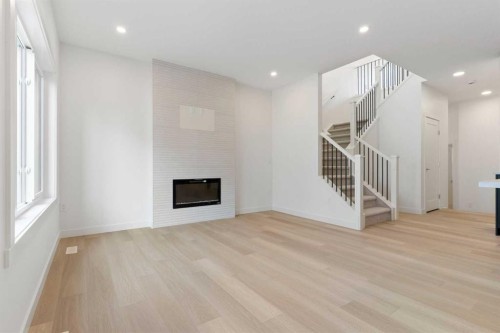91 Heritage Manor, Cochrane, AB - Indoor With Fireplace