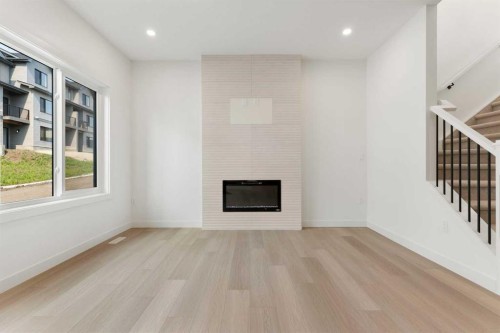 91 Heritage Manor, Cochrane, AB - Indoor With Fireplace