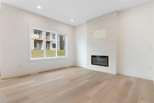 91 Heritage Manor, Cochrane, AB - Indoor Photo Showing Other Room With Fireplace