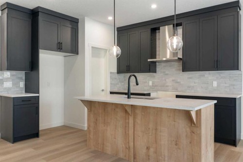 91 Heritage Manor, Cochrane, AB - Indoor Photo Showing Kitchen With Upgraded Kitchen