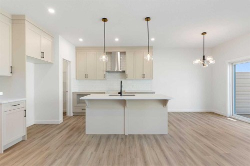 83 Heritage Manor, Cochrane, AB - Indoor Photo Showing Kitchen With Upgraded Kitchen