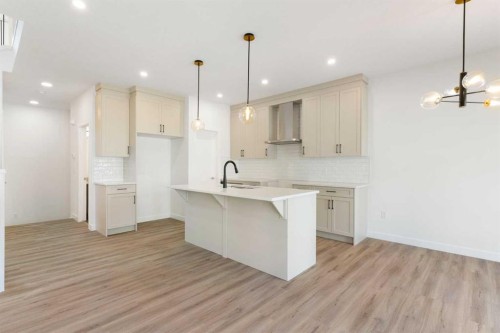83 Heritage Manor, Cochrane, AB - Indoor Photo Showing Kitchen With Upgraded Kitchen