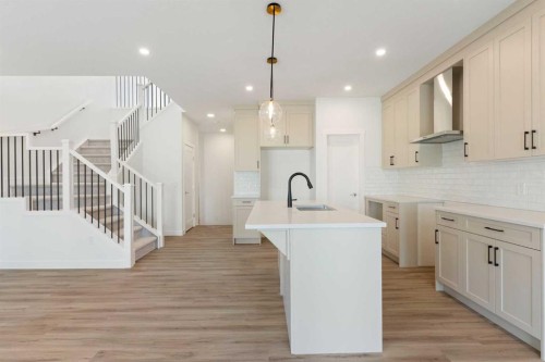 83 Heritage Manor, Cochrane, AB - Indoor Photo Showing Kitchen With Upgraded Kitchen
