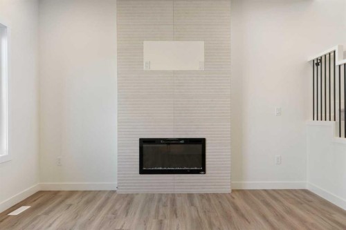 83 Heritage Manor, Cochrane, AB - Indoor With Fireplace