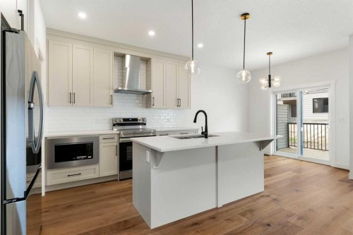 107 Heritage Manor, Cochrane, AB - Indoor Photo Showing Kitchen With Upgraded Kitchen