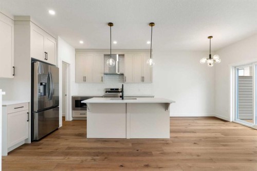 107 Heritage Manor, Cochrane, AB - Indoor Photo Showing Kitchen With Double Sink With Upgraded Kitchen