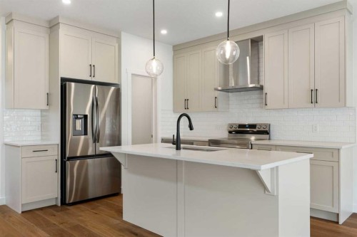 107 Heritage Manor, Cochrane, AB - Indoor Photo Showing Kitchen With Upgraded Kitchen