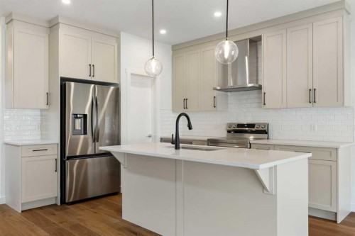 107 Heritage Manor, Cochrane, AB - Indoor Photo Showing Kitchen With Upgraded Kitchen