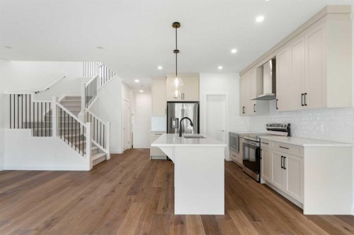 107 Heritage Manor, Cochrane, AB - Indoor Photo Showing Kitchen With Upgraded Kitchen
