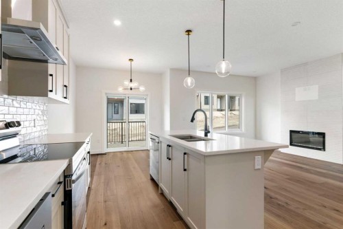107 Heritage Manor, Cochrane, AB - Indoor Photo Showing Kitchen With Double Sink With Upgraded Kitchen