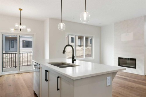 107 Heritage Manor, Cochrane, AB - Indoor Photo Showing Kitchen With Double Sink