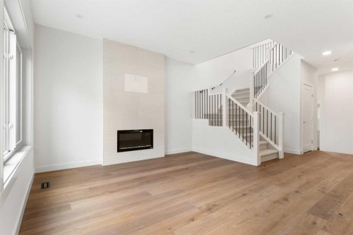 107 Heritage Manor, Cochrane, AB - Indoor With Fireplace