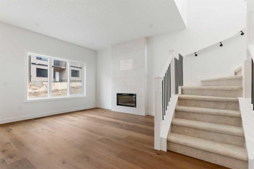 107 Heritage Manor, Cochrane, AB - Indoor With Fireplace