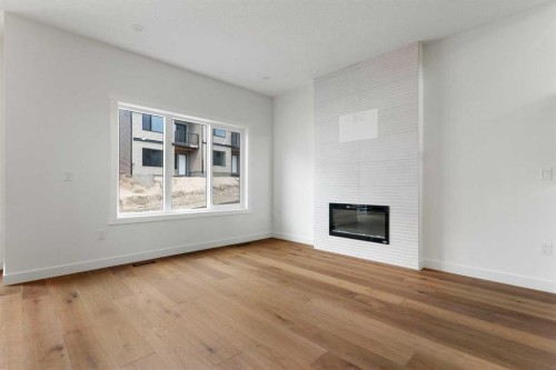 107 Heritage Manor, Cochrane, AB - Indoor Photo Showing Other Room With Fireplace