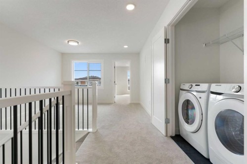 107 Heritage Manor, Cochrane, AB - Indoor Photo Showing Laundry Room