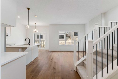 107 Heritage Manor, Cochrane, AB - Indoor Photo Showing Kitchen With Upgraded Kitchen