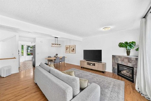 357 Regal Park Ne, Calgary, AB - Indoor Photo Showing Living Room With Fireplace