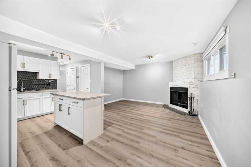 74 Fonda Drive Se, Calgary, AB - Indoor Photo Showing Kitchen With Fireplace