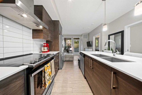 105-2231 Mahogany Boulevard Se, Calgary, AB - Indoor Photo Showing Kitchen With Double Sink With Upgraded Kitchen