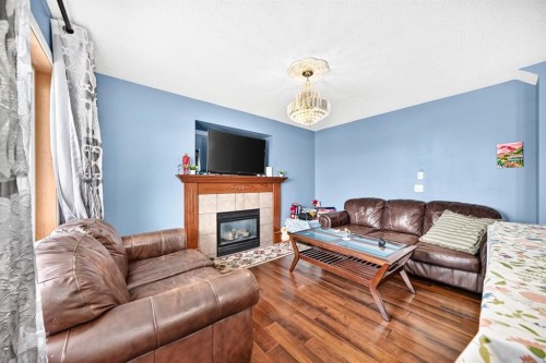 308 Taracove Estate Drive Ne, Calgary, AB - Indoor Photo Showing Living Room With Fireplace