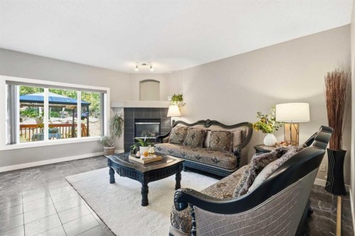 242 Tusslewood Grove Nw, Calgary, AB - Indoor Photo Showing Living Room With Fireplace