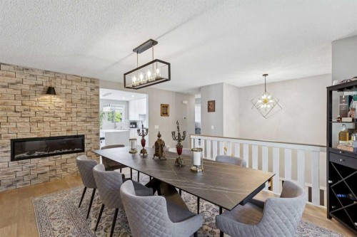 1208 Ranchlands Boulevard Nw, Calgary, AB - Indoor Photo Showing Dining Room With Fireplace