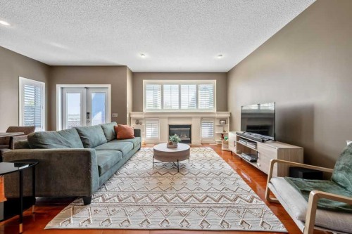 418 Bridlecreek Green Sw, Calgary, AB - Indoor Photo Showing Living Room With Fireplace