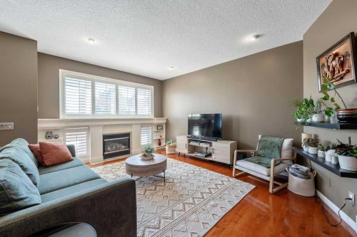 418 Bridlecreek Green Sw, Calgary, AB - Indoor Photo Showing Living Room With Fireplace
