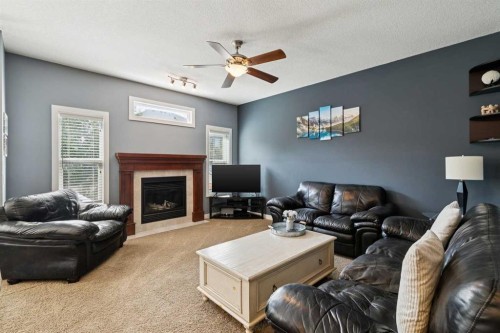 105 Bridlerange Place Sw, Calgary, AB - Indoor Photo Showing Living Room With Fireplace