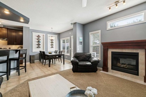 105 Bridlerange Place Sw, Calgary, AB - Indoor Photo Showing Living Room With Fireplace
