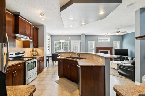 105 Bridlerange Place Sw, Calgary, AB - Indoor Photo Showing Kitchen With Stainless Steel Kitchen With Double Sink