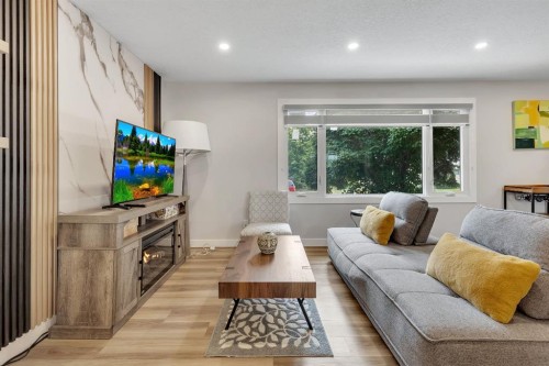 8031 Huntwick Hill Ne, Calgary, AB - Indoor Photo Showing Living Room With Fireplace