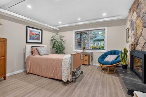 22 Varmoor Place Nw, Calgary, AB - Indoor Photo Showing Bedroom With Fireplace