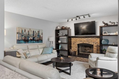 244 Scurfield Place Nw, Calgary, AB - Indoor Photo Showing Living Room With Fireplace