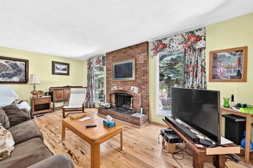 350 Silver Ridge Crescent Nw, Calgary, AB - Indoor Photo Showing Living Room With Fireplace