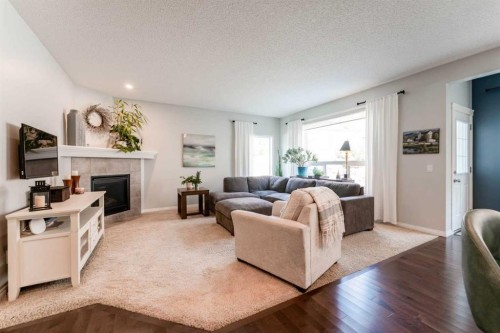 47 Panatella Bay Nw, Calgary, AB - Indoor Photo Showing Living Room With Fireplace